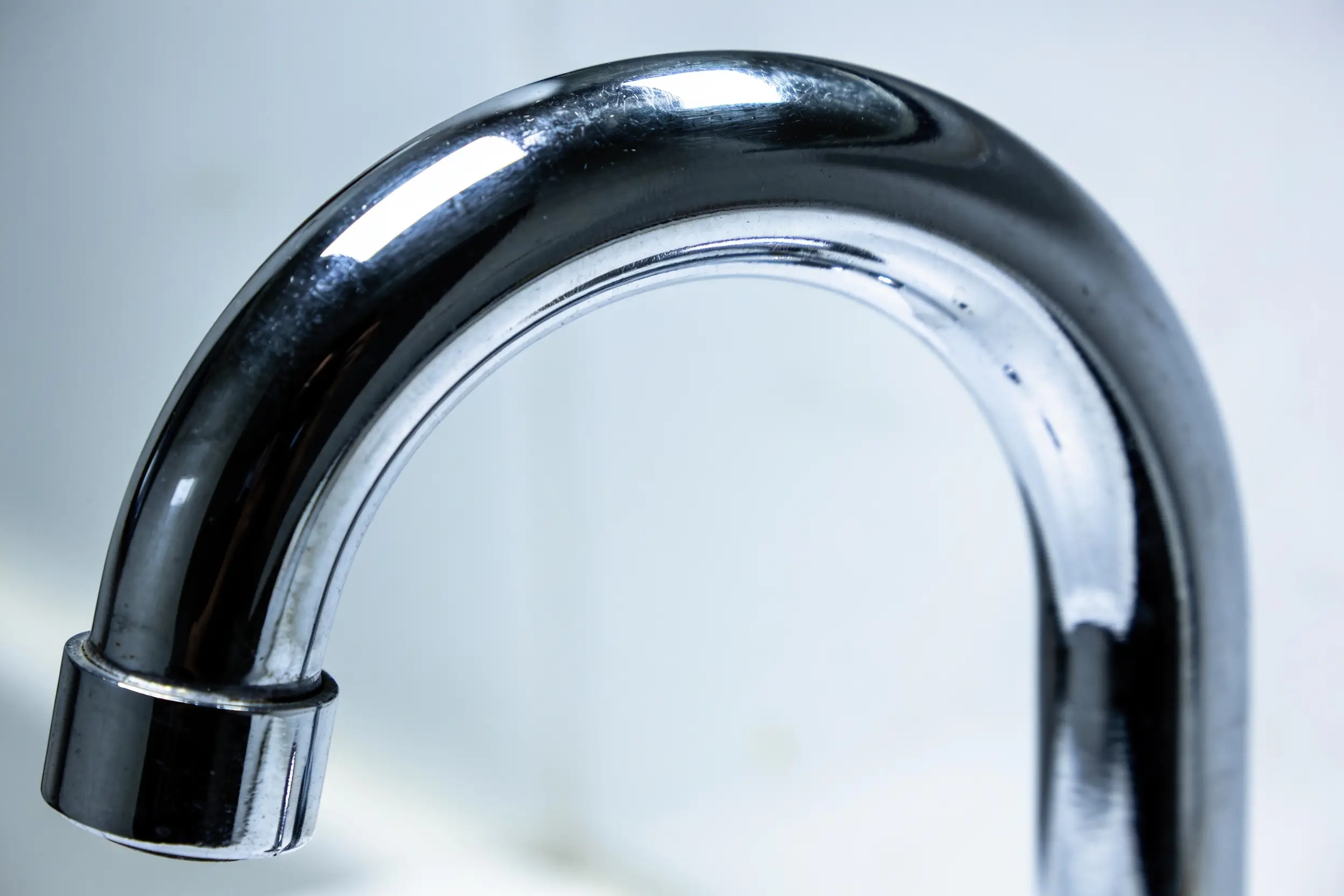 Macro view of the curve of a polished chrome drain trap bend